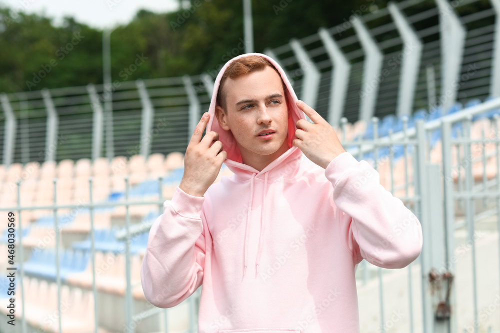 Young guy in stylish hoodie outdoors