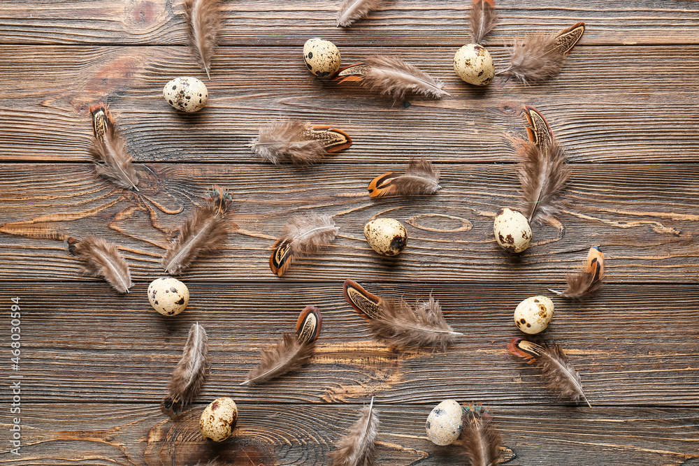 Beautiful pheasant feathers and eggs on wooden background