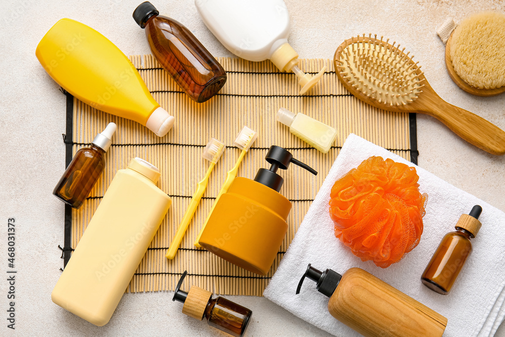 Set of bath accessories and bamboo mat on light background, closeup