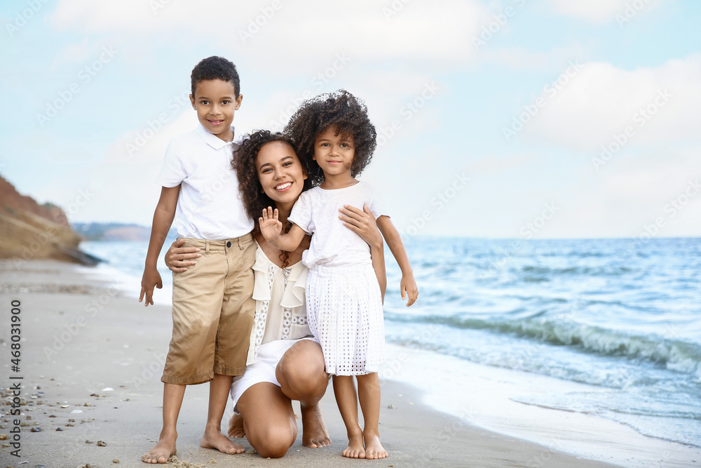 African-American children with mother on sea beach