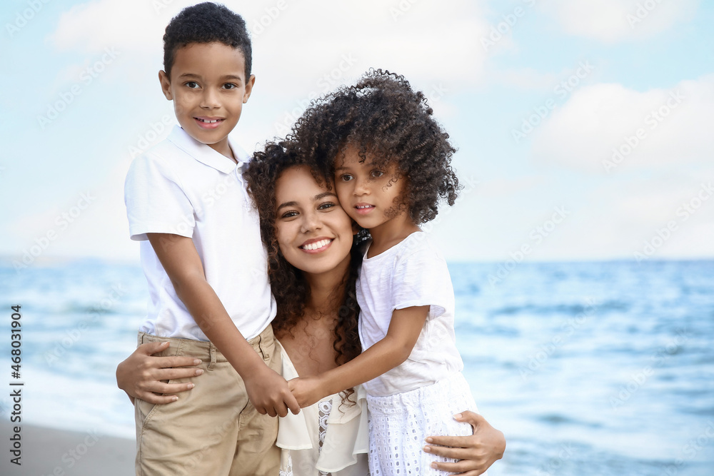 African-American children with mother on sea beach