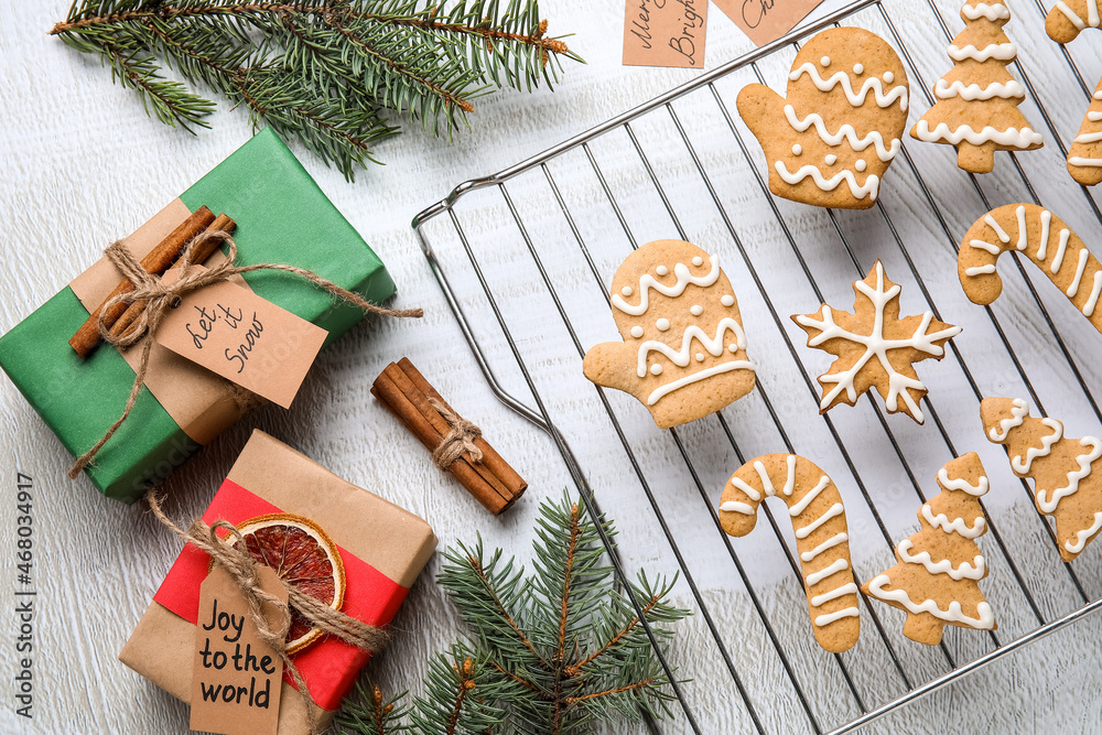 Grid with Christmas gingerbread cookies and gifts on light background