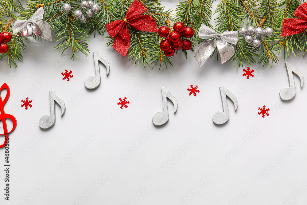 Note signs with Christmas decor and fir branches on light background