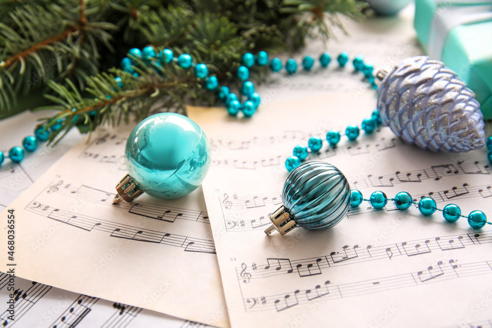 Christmas balls with beads on note sheets, closeup