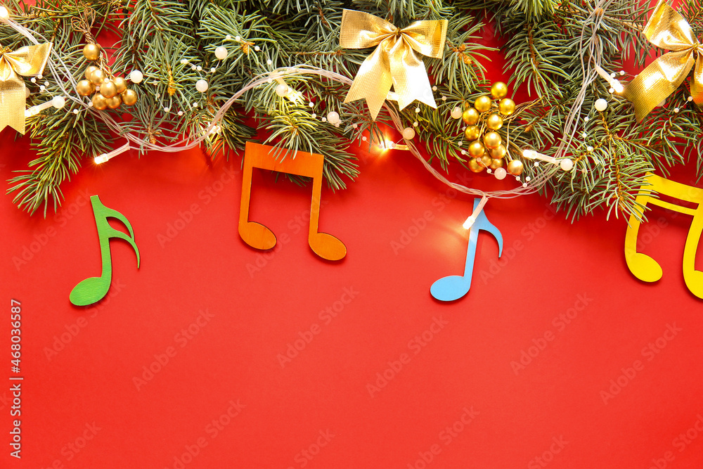 Note signs with Christmas decor and fir branches on red background