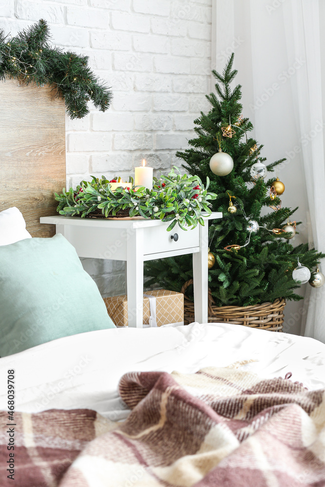 Stylish interior of bedroom decorated for Christmas celebration