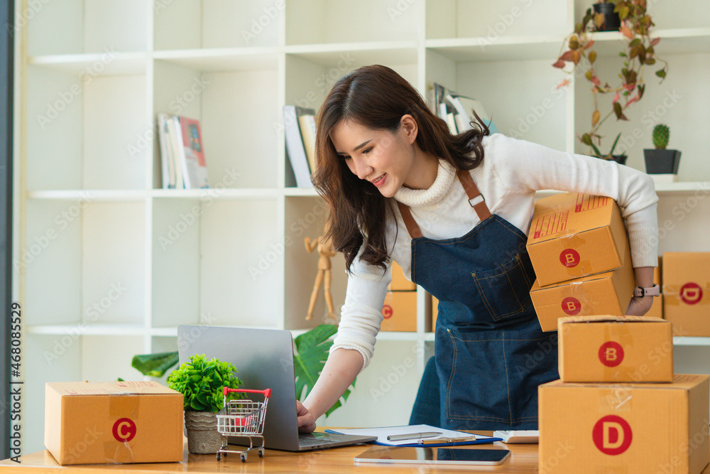 Young Asian woman entrepreneur working at home office, BOX,smartphone,laptop, online, marketing, pac