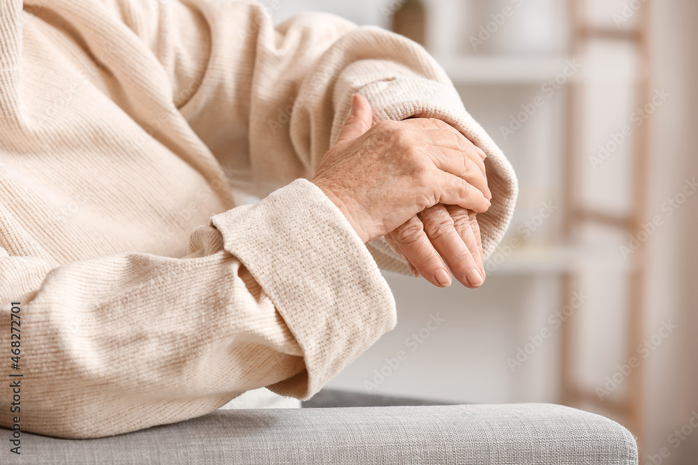 Hands of elderly woman at home