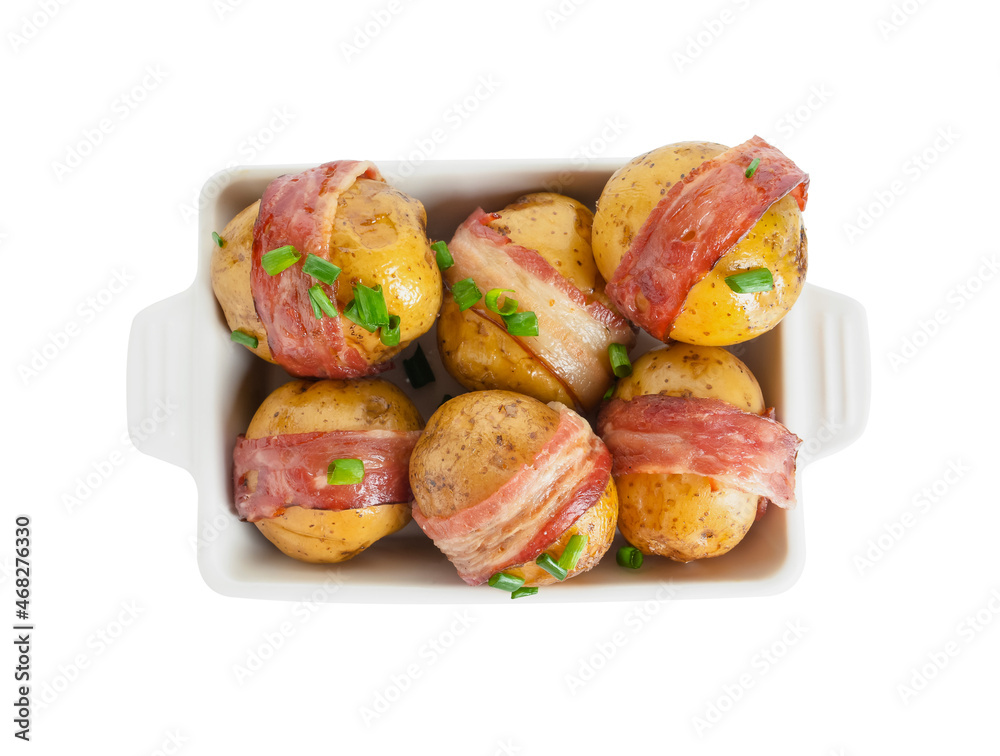 Baking dish of tasty baked potatoes with bacon on white background