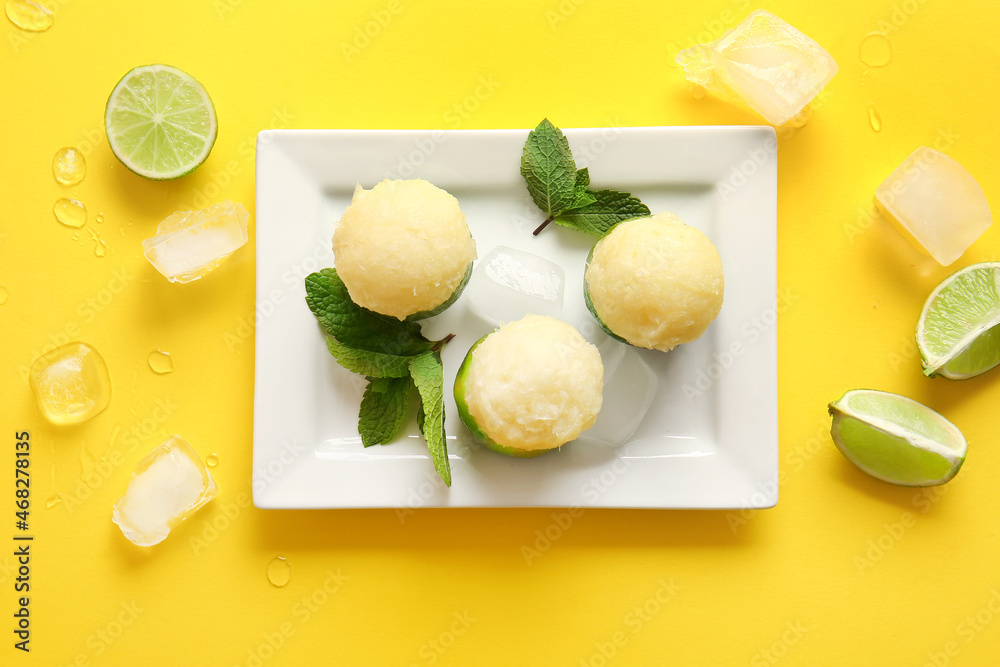 Plate with tasty ice creams in lime peels on color background