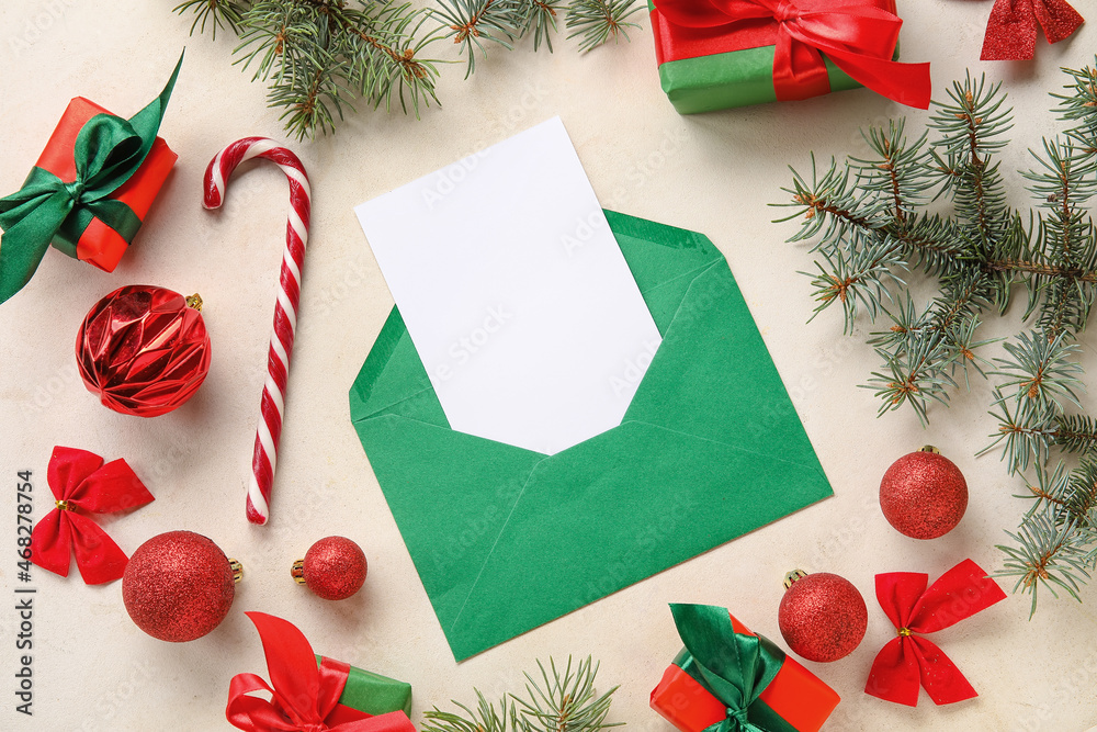 Envelope with blank card, gifts and Christmas decor on white background