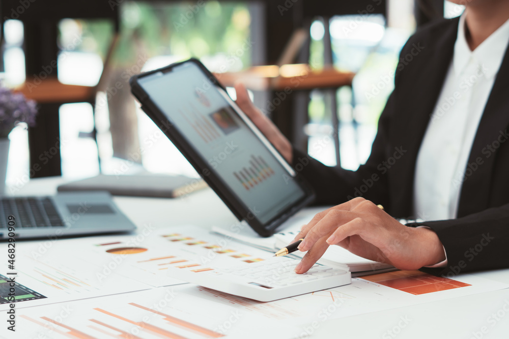 Businessman discussing analysis charts or graphs on desk table and using laptop computer.Close up ma