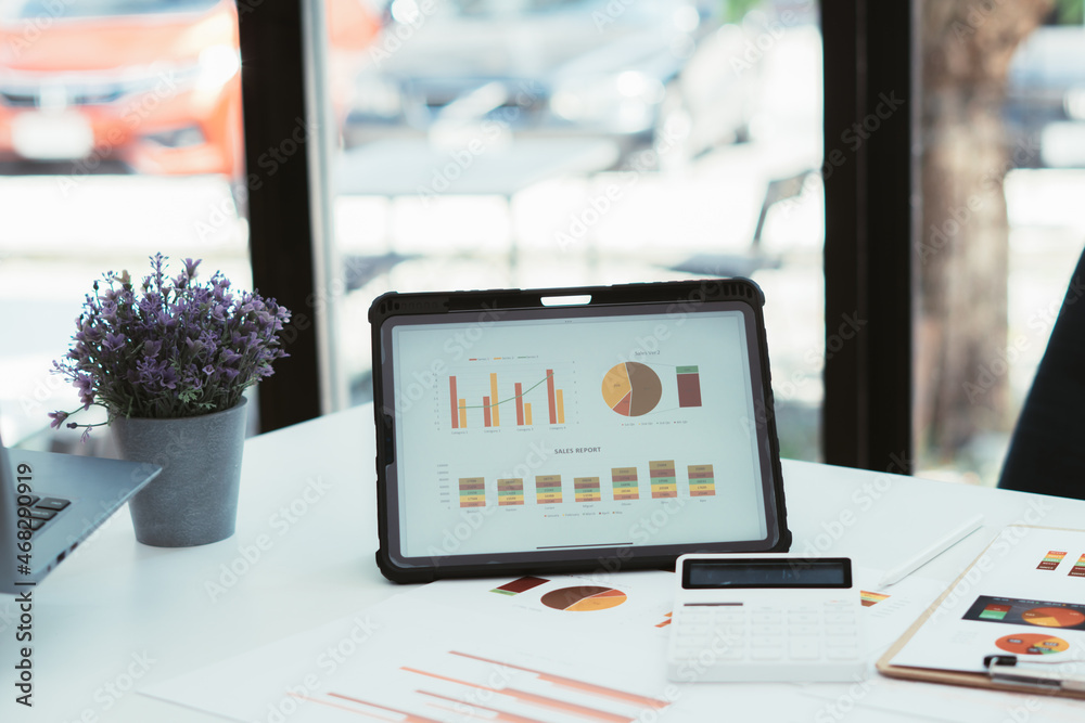 digital tablet computer with graphs and charts elements on screen with analytical data by summary re