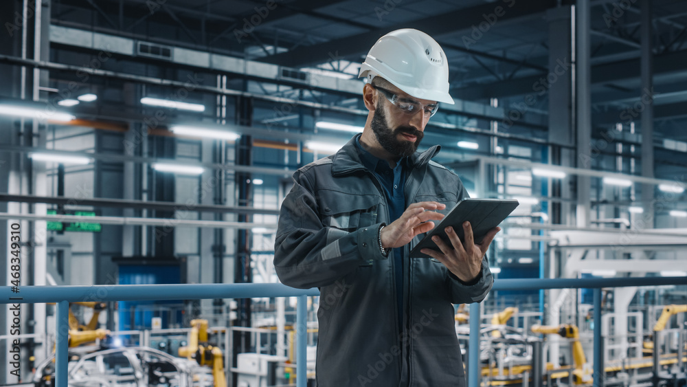 Portrait of Automotive Industry Engineer in Safety Glasses and Uniform Using Laptop at Car Factory F