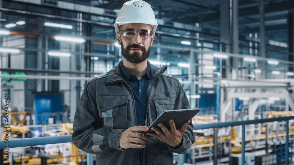 Portrait of Automotive Industry Engineer in Safety Glasses and Uniform Using Laptop at Car Factory F