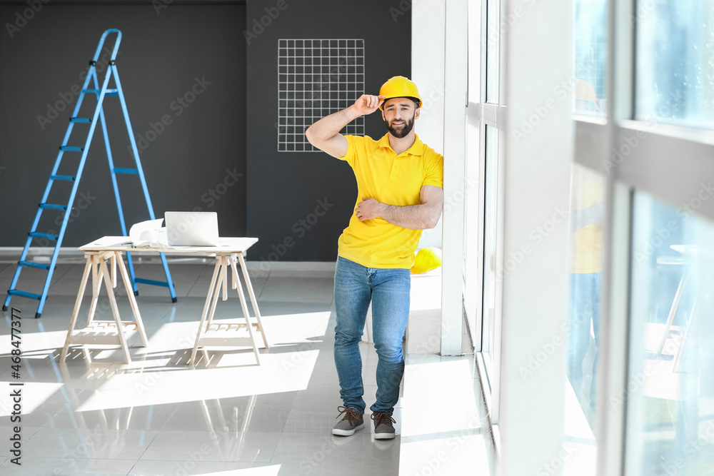 Construction worker with hardhat near window in room