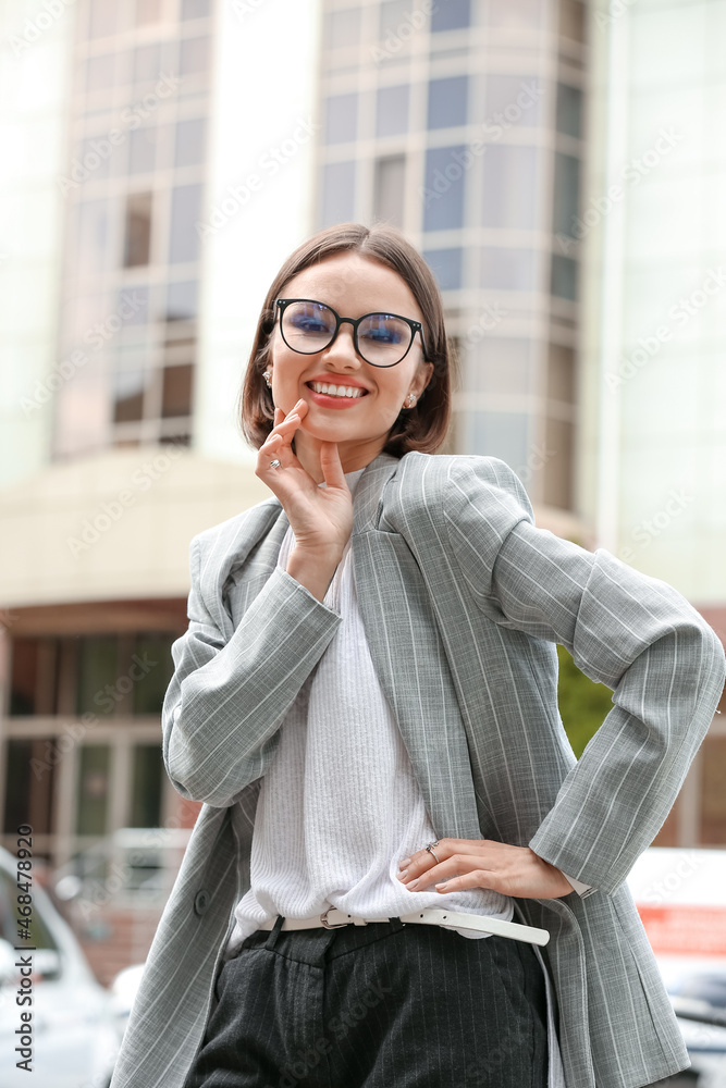 Happy young woman with stylish accessories on city street