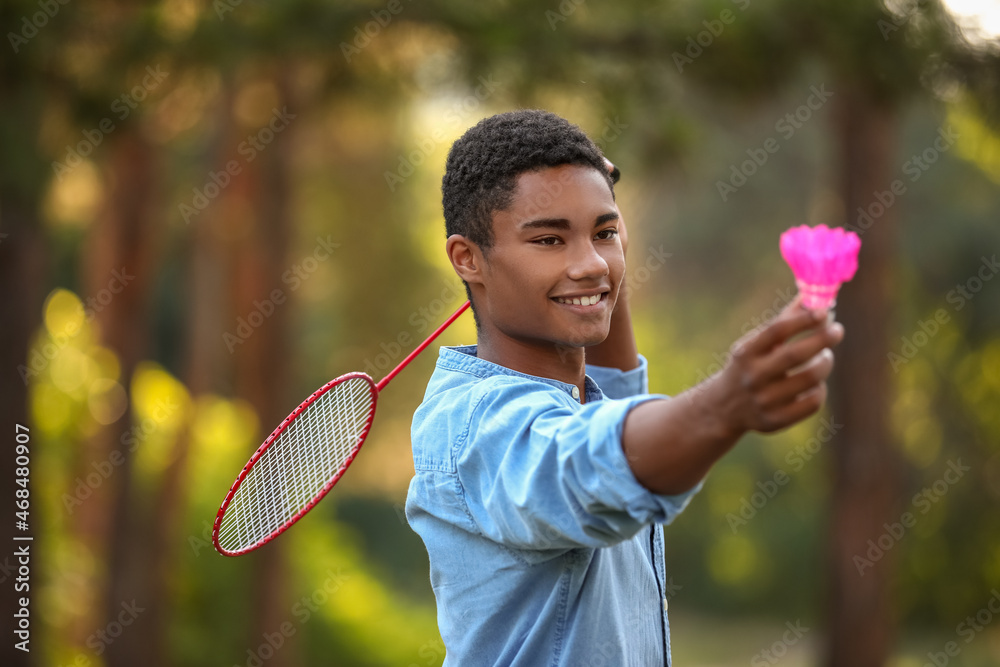 Male African-American badminton player in park