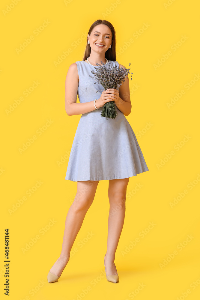 Beautiful young woman with bouquet of lavender on color background