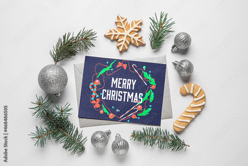 Greeting card with text MERRY CHRISTMAS, fir tree branches, Christmas balls and cookies on white bac