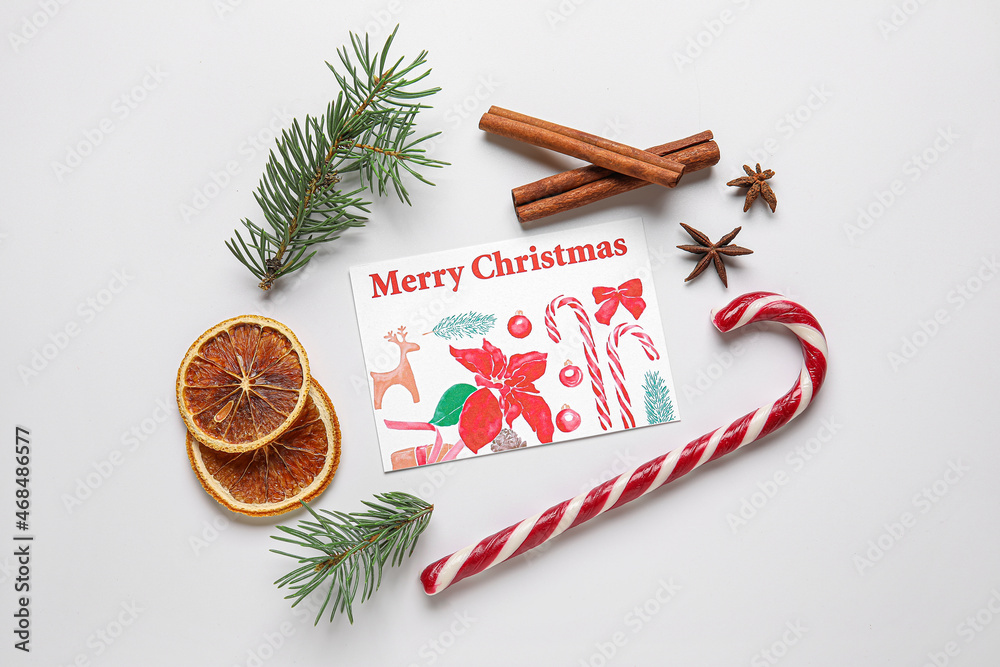 Greeting card with text MERRY Christmas, fir tree branches and candy cane on white background