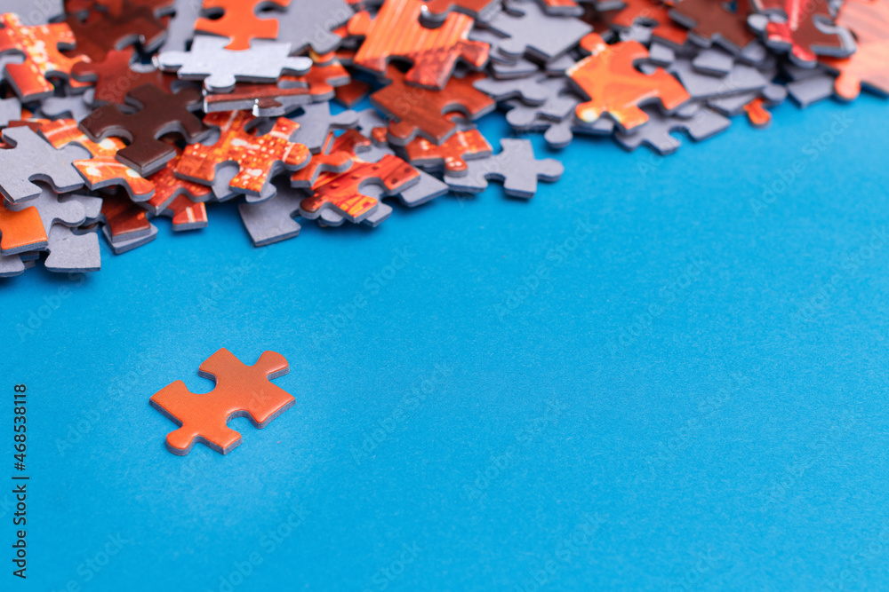 Mixed Peaces of a Colorful Jigsaw Puzzle Lie on the Blue Background With Copy Space - Strategy and S