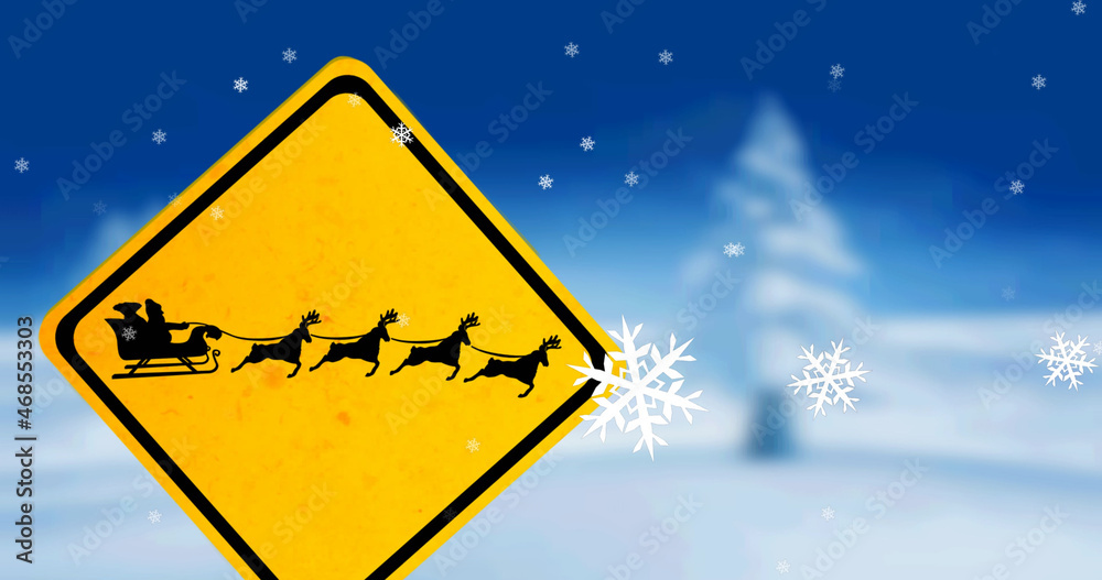 Image of christmas snowflakes falling over santa sleigh sign on blue background