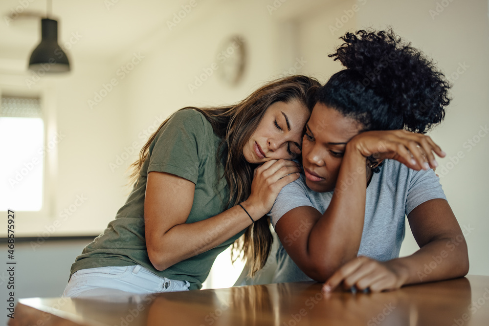 Nervous african-american woman, being calmed by her friend