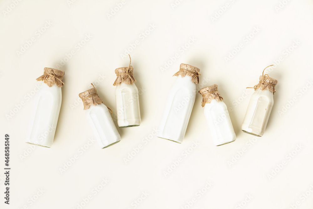 on dairy plant based milk in bottles on light background. Alternative lactose free milk substitute, 