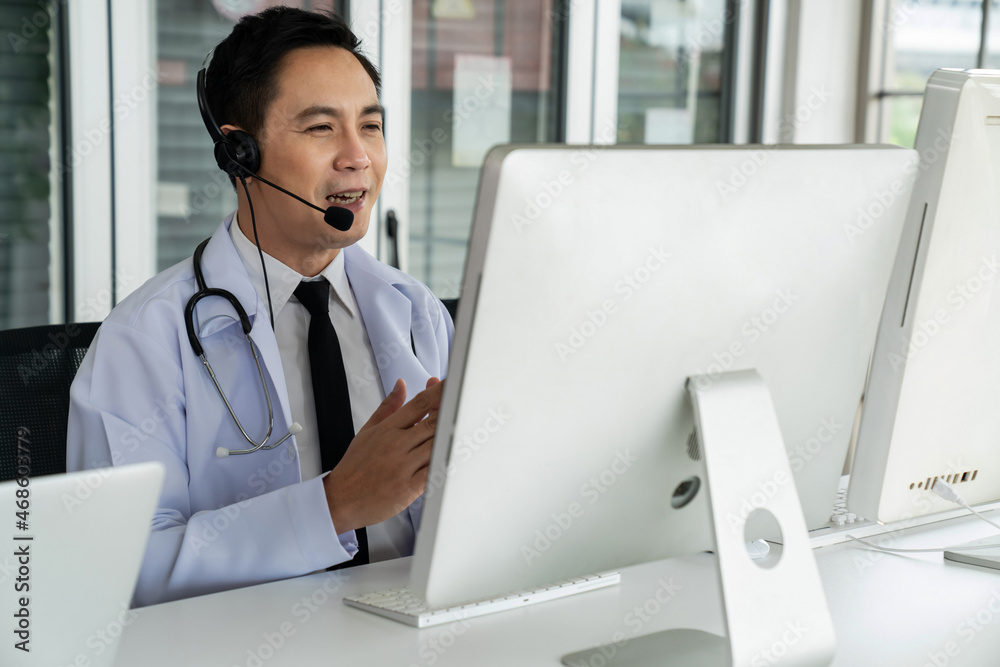 Doctor wearing headset talking actively on video call in a clinic or hospital . Concept of telehealt