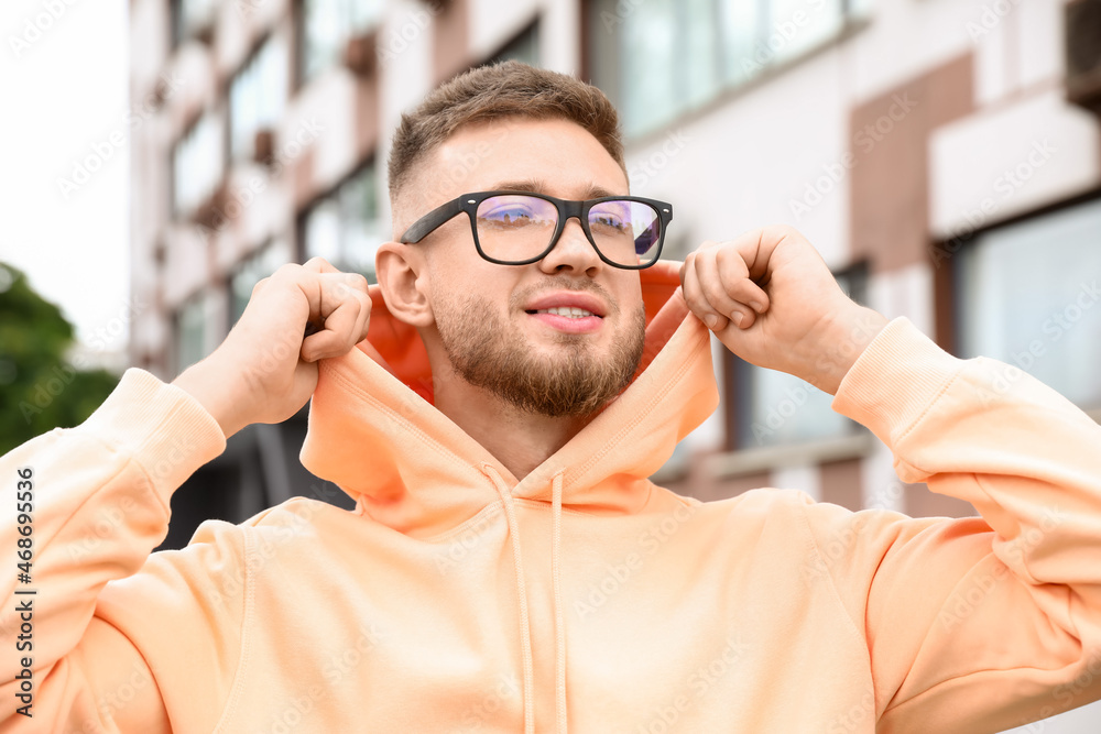 Young guy in stylish hoodie outdoors