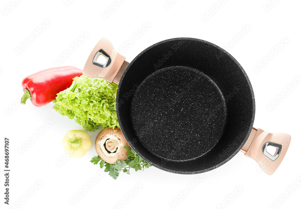 Cooking pot with fresh vegetables on white background