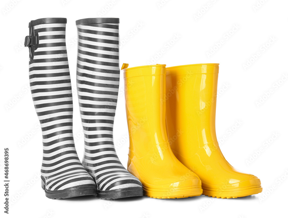 Two pairs of rubber boots on white background