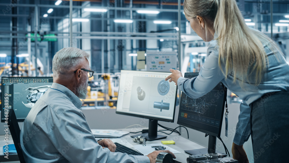 Car Factory Office: Female Project Manager Talks to Male Chief Automotive Engineer Working on Comput