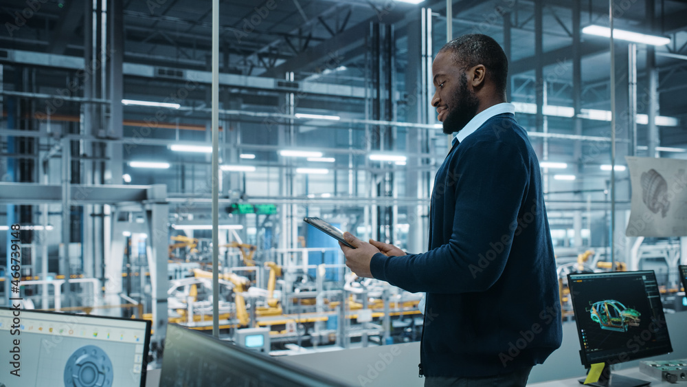 Car Factory Office: Portrait of Successful Black Male Chief Engineer Using Tablet Computer in Automa