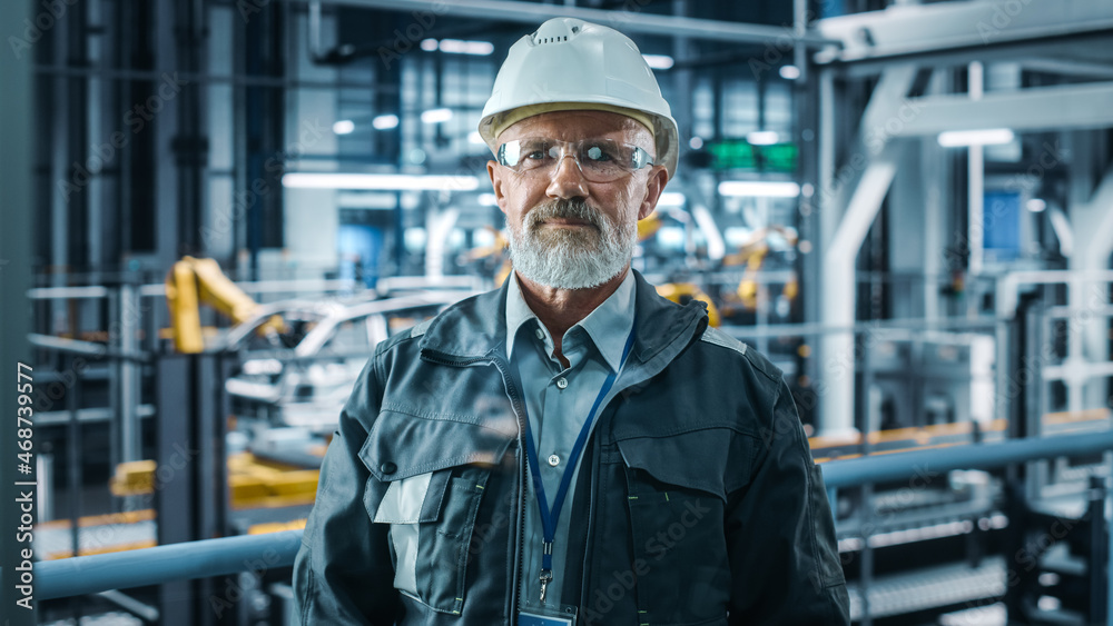 Car Factory Office: Portrait of Senior White Male Chief Engineer Looking at Camera and Smiling. Prof