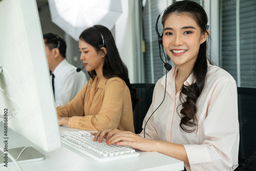 Business people wearing headset working actively in office . Call center, telemarketing, customer su