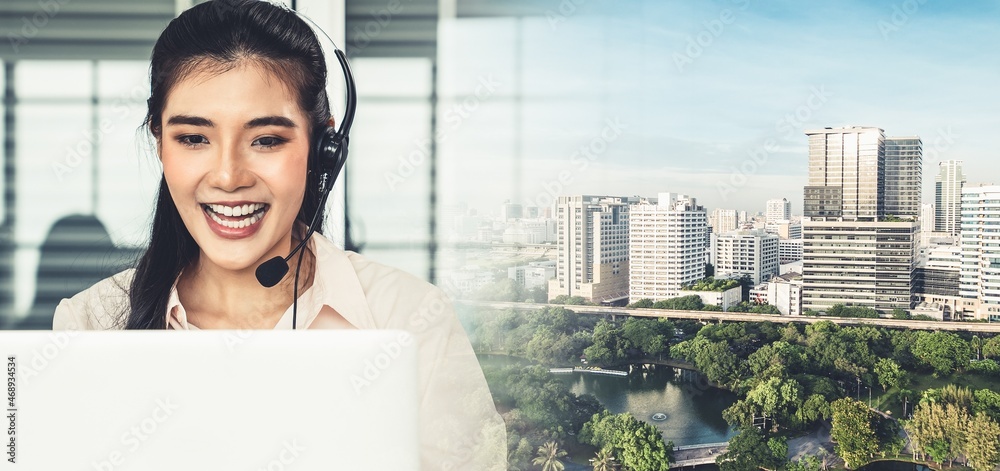 Businesswoman wearing headset working actively in office . Call center, telemarketing, customer supp