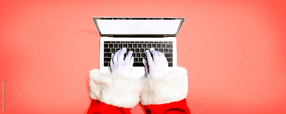 Santa Claus using a laptop computer from above