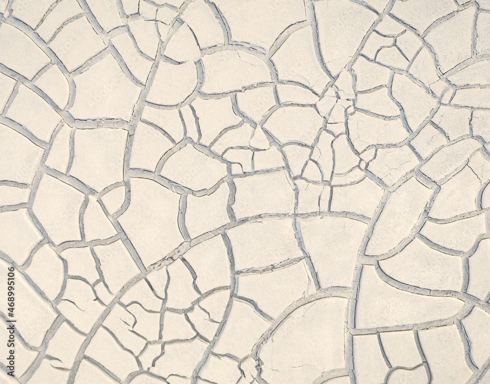 Cracked white clay on dried lakebed, natural beige pattern