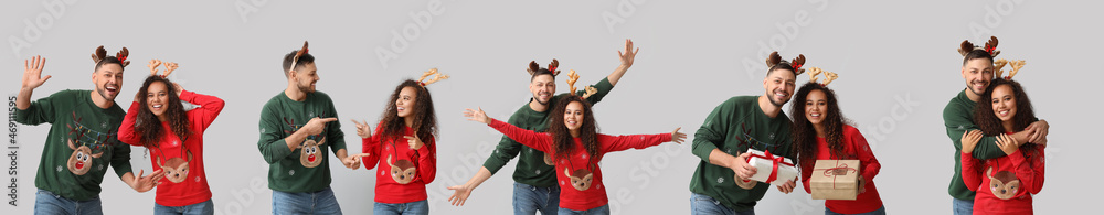 Happy couple in Christmas sweaters on light background