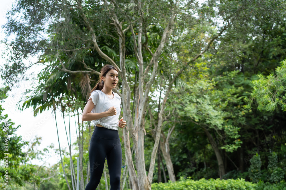 Asian young beautiful sport woman running on street in public park. 