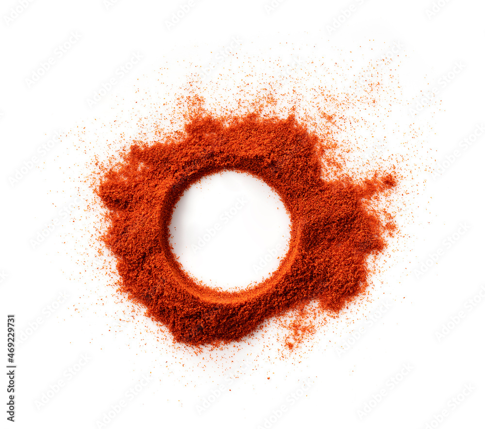 A round frame made of red pepper powder on a white background.