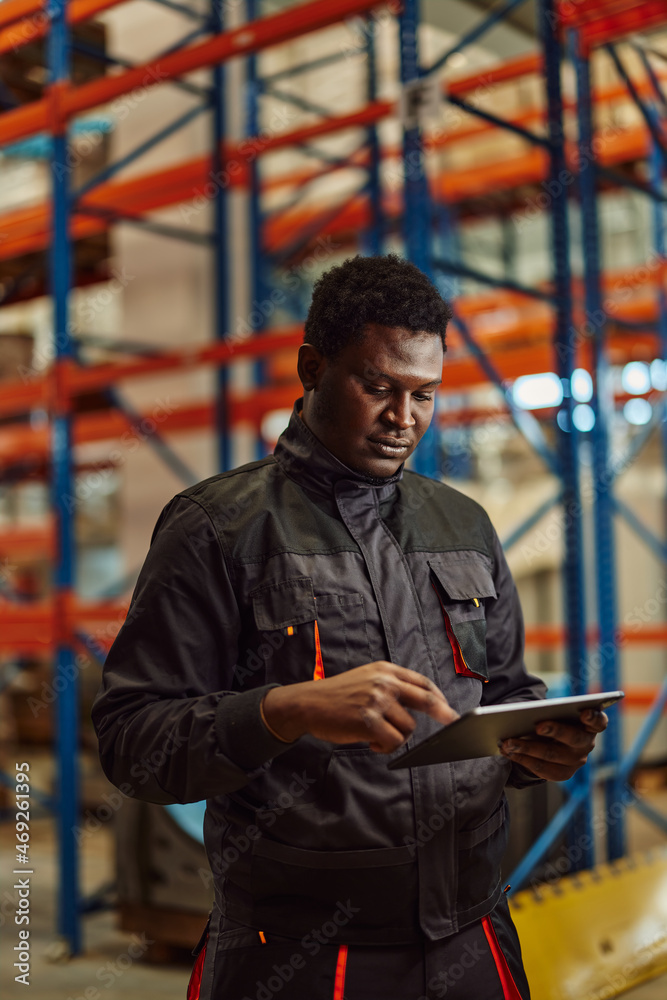 Focused african-american man, easying his job with a tablet