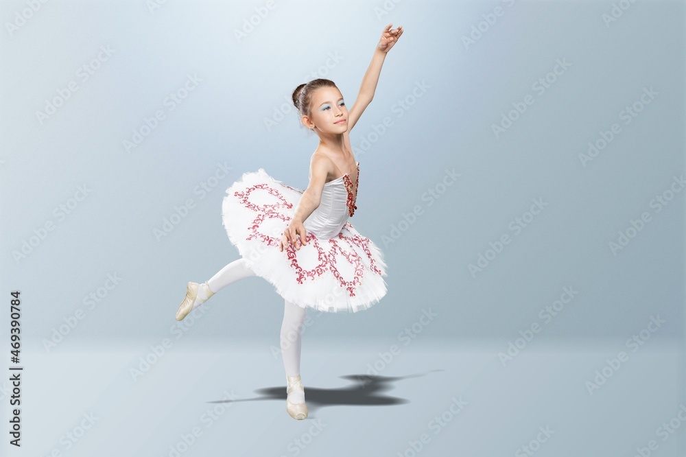 Tips on toes. Young graceful ballerina dancing alone on background.