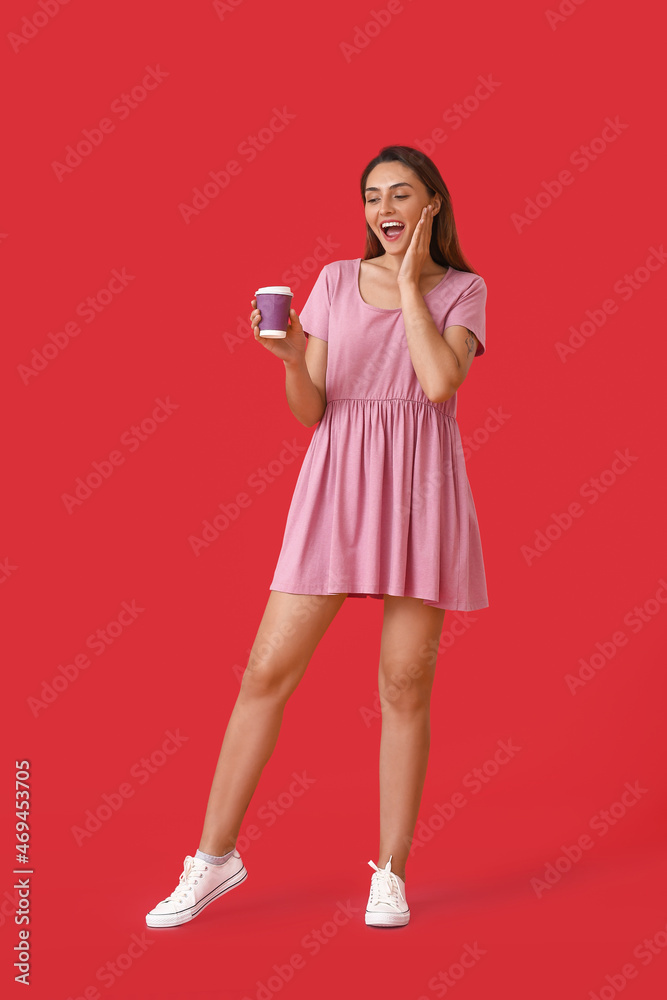 Beautiful woman with cup of coffee on color background