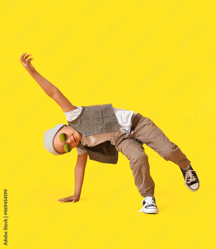 Cute dancing African-American boy on color background