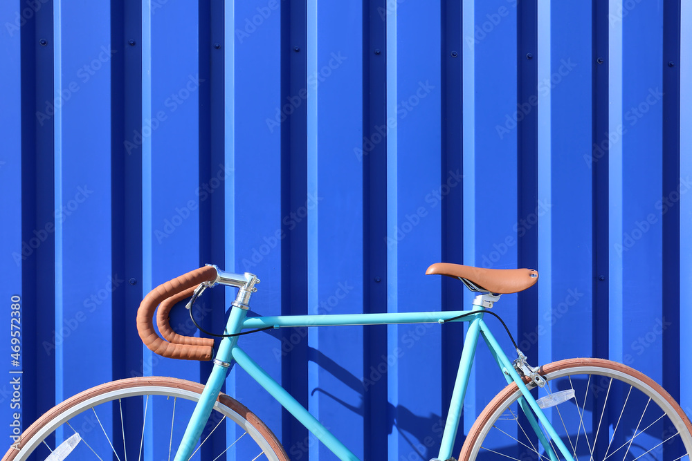 Sport bicycle near blue wall