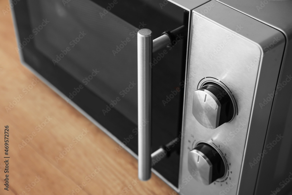 Microwave oven on wooden tabletop in kitchen