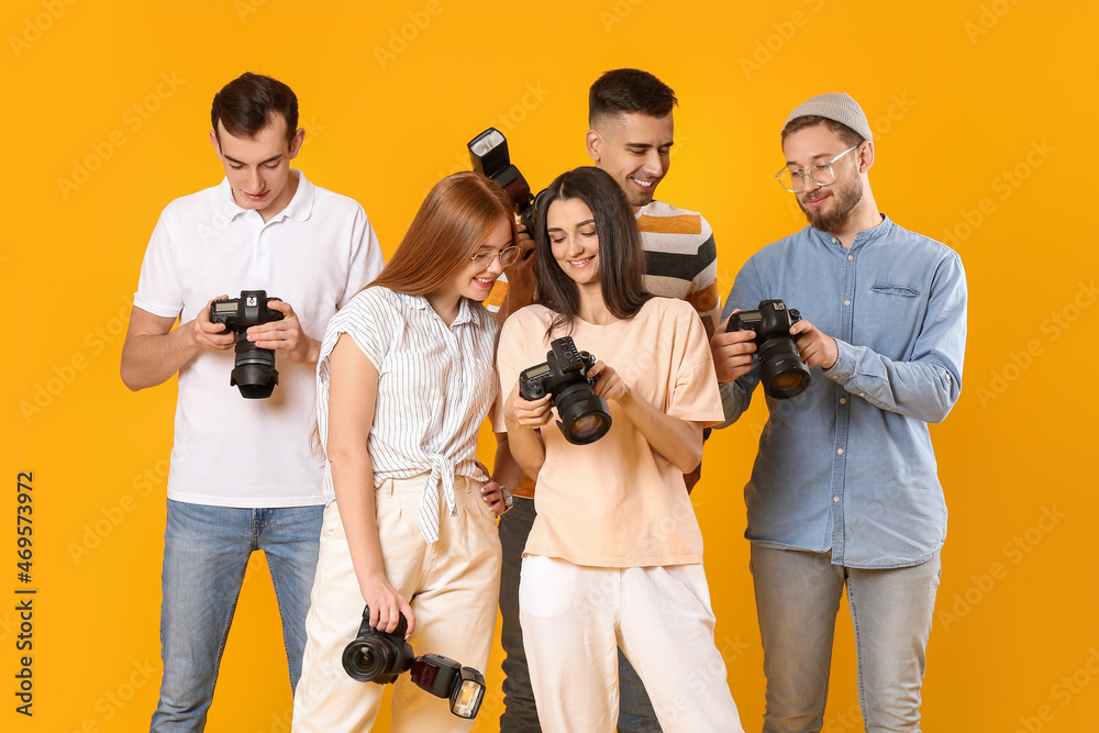 Group of photographers on color background